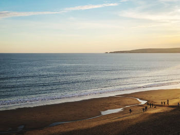 Scenic view of beach against sky during sunset