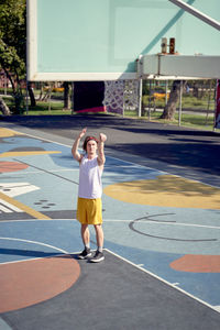 Boy playing with ball in background