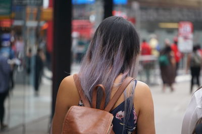 Rear view of woman on street in city