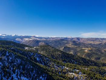 Scenic view of mountains against blue sky