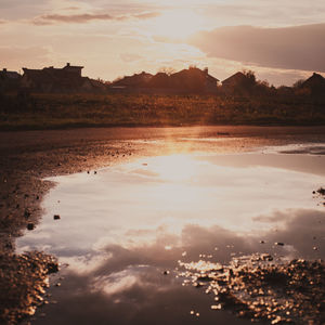 Scenic view of lake against sky during sunset