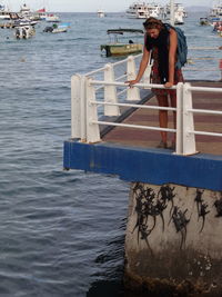 Portrait of man standing on boat in sea