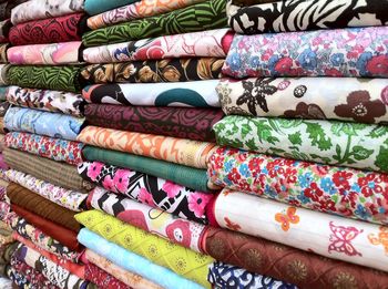 Close-up of stacked fabrics for sale in store