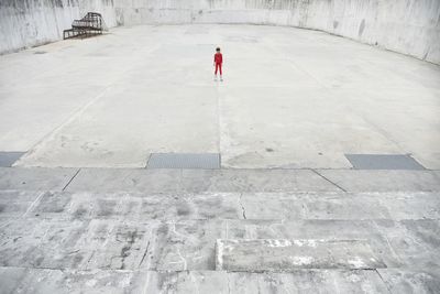 Rear view of man walking on road