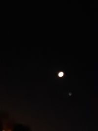 Low angle view of moon against sky at night