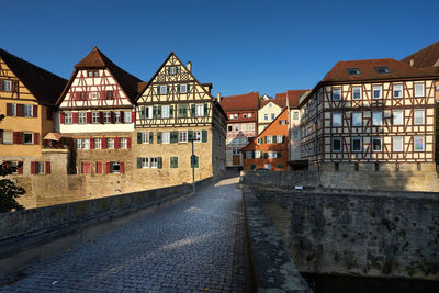 Canal amidst buildings in town against sky
