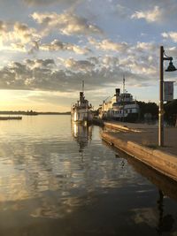 Boats in marina at sunset