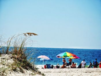 Scenic view of beach against clear blue sky