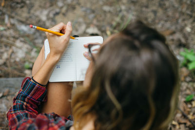 Portrait of woman holding pencils