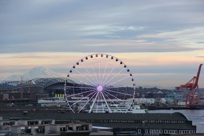 Ferris wheel in city against sky