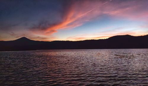 Scenic view of lake against sky during sunset