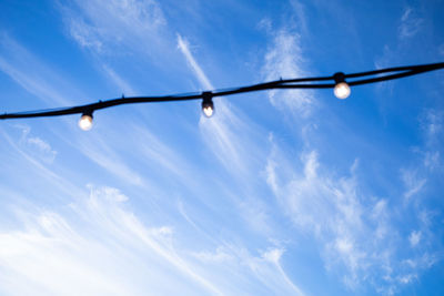 Low angle view of light bulb against sky