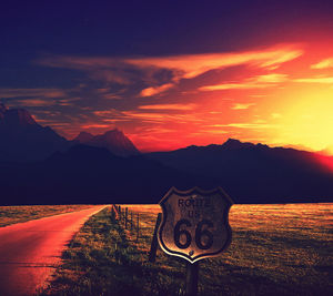 Scenic view of illuminated mountain against sky at sunset