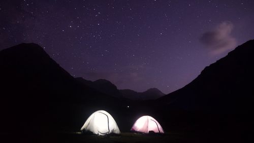 Scenic view of mountains against sky at night