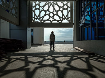 Rear view of man standing in building