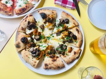 High angle view of pizza served on table