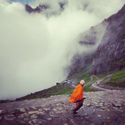 Rear view of man walking on mountain