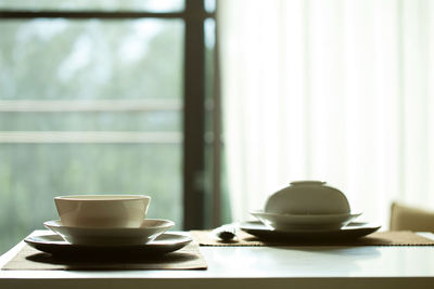 White dishes on table.breakfast table on sunny morning