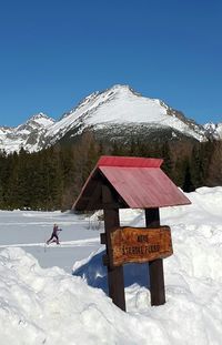 Scenic view of snow covered field against clear blue sky