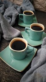 High angle view of coffee in cups on table