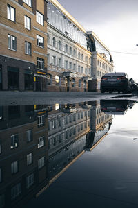 Reflection of building in canal against sky