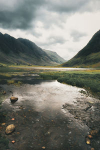 Scenic view of lake and mountains against sky in glencoe