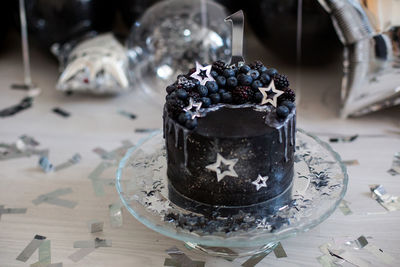 Black cake with stars and berries with the number one