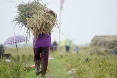 Rear view of woman standing on field