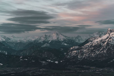 Scenic view of snowcapped mountains against sky during sunset