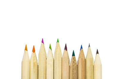 Close-up of colored pencils against white background