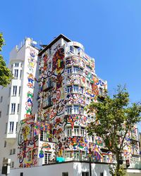 Low angle view of buildings against clear blue sky