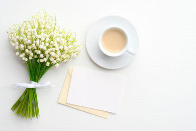 Close-up of white and coffee served on table