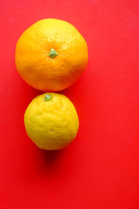 Close-up of yellow fruit against red background