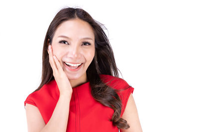 Portrait of a smiling young woman over white background