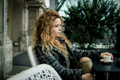 Woman having coffee outdoors