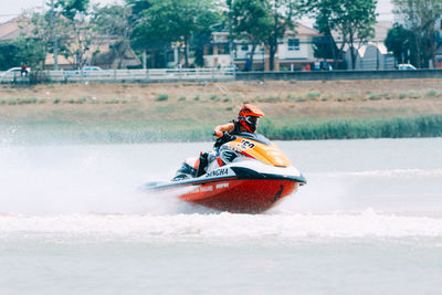 People riding motor boat in water