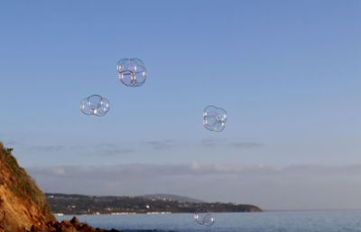 Bubbles over sea against sky
