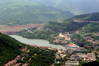 High angle view of river amidst trees against mountains