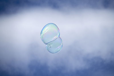 Close-up of bubbles against rainbow in sky