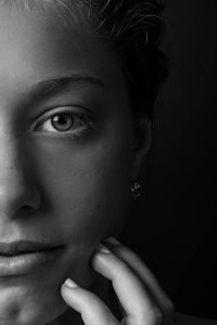 Close-up portrait of woman in darkroom