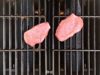 Directly above view of meat on barbecue grill