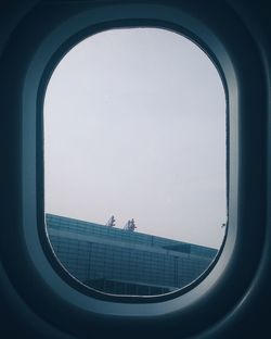 Panoramic view of sea against sky seen through window
