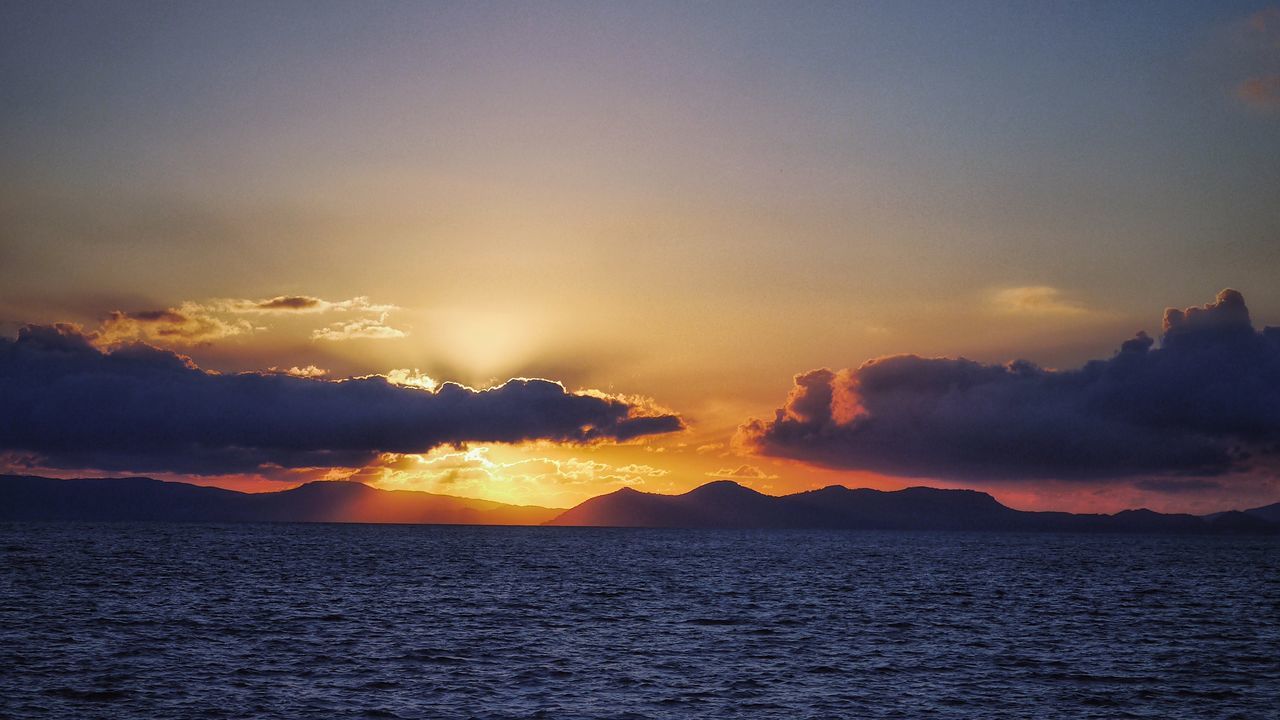 sunset, waterfront, water, scenics, sea, tranquil scene, beauty in nature, tranquility, orange color, sky, idyllic, nature, sun, rippled, silhouette, cloud - sky, horizon over water, outdoors, no people, cloud