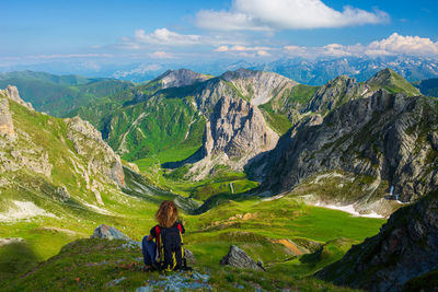 Woman looking at mountains against sky