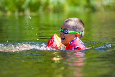 Portrait of boy swimming in water