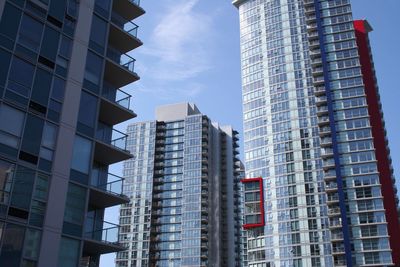 Low angle view of buildings in city against sky