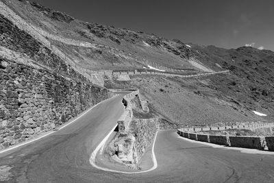 Road by mountain against sky