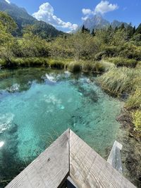 High angle view of swimming pool by lake against sky