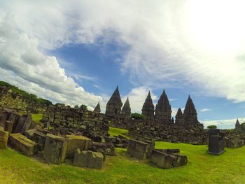 Ruins of temple against cloudy sky