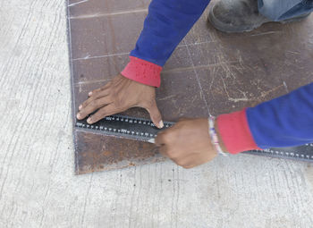 Low section of woman working on wooden floor